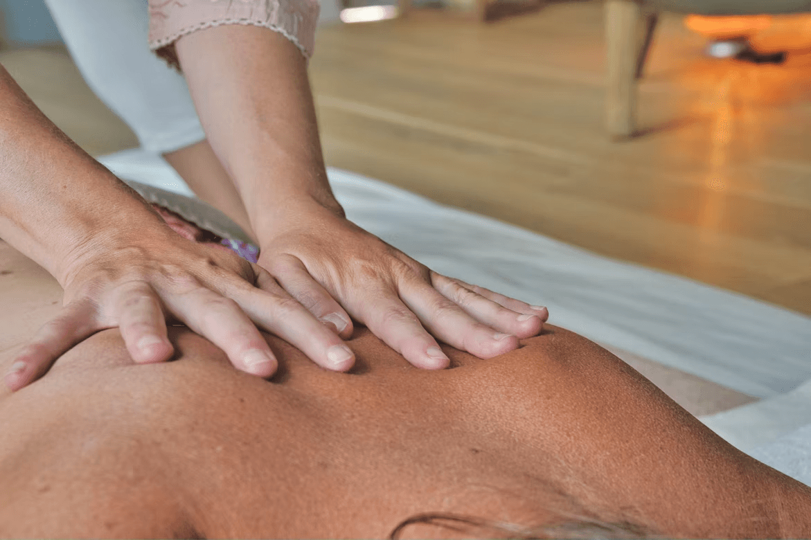 Close-up of a massage therapist's hands performing therapeutic back massage